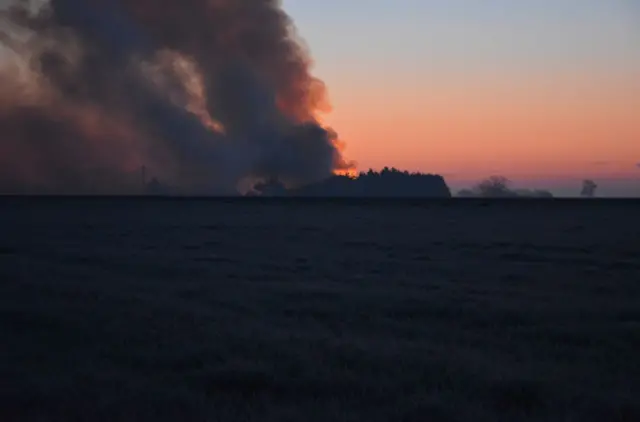 A view of the fire, across fields, taken in the evening of the weekend it broke out