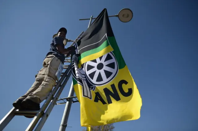 ANC activists hang flags on lamp post