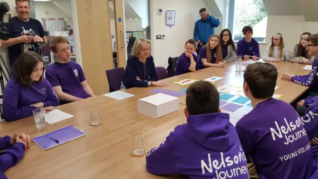 Liz Truss seated at a table with youngsters at the Nelson's Journey charity