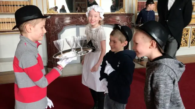 Children learning to be butlers