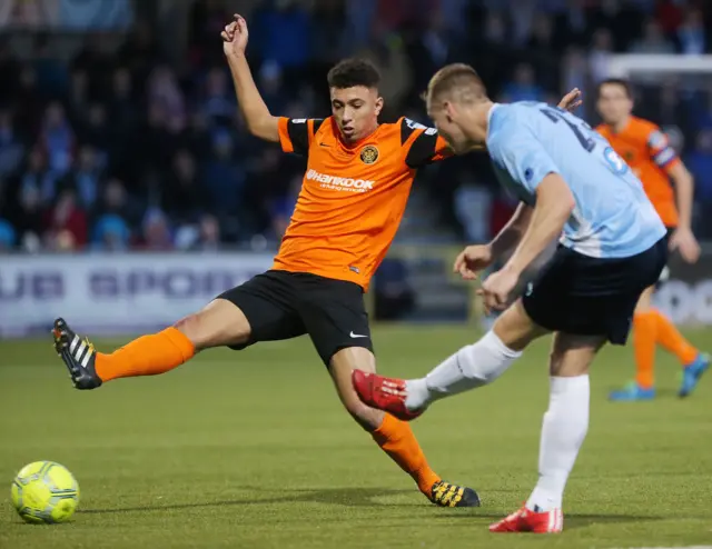 Carrick's TJ Murray in action against Ballymena's Leroy Millar