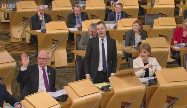 The government benches react to Labour MSP Jackie Baillie's closing speech