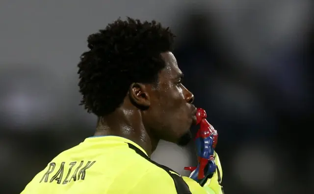 Brimah Razak kisses a spiderman toy