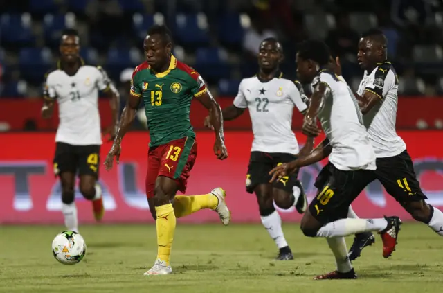 Cameroon"s Christian Bassogog in action with Ghana"s Frank Acheampong, Daniel Amartey and Wakaso Mubarak