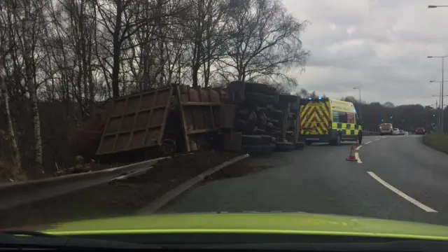 The overturned lorry on the slip road