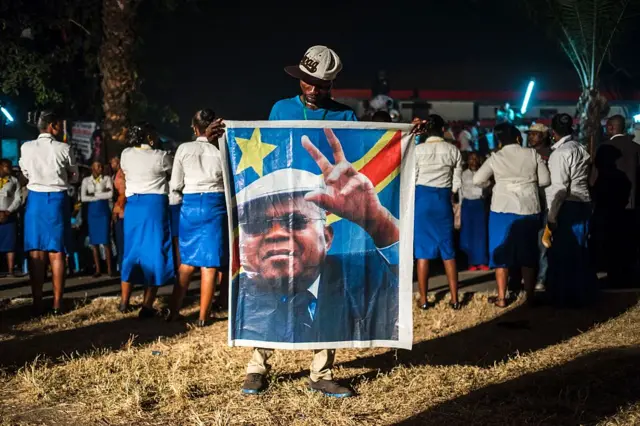 Supporter holding portrait of Etienne Tshisekedi