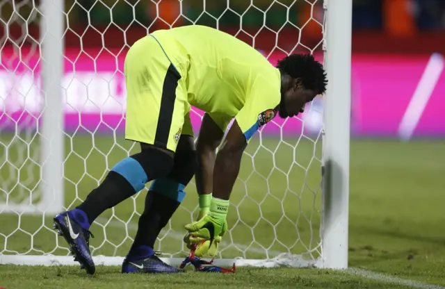Ghana"s Brimah Razak picks up a spiderman toy from the side of the pitch