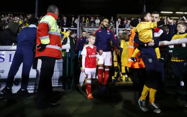 Theo Walcott leads out the team