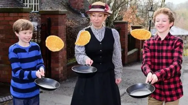 Three people flipping pancakes