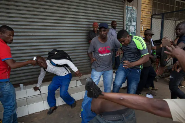 A vigilante mob attacks a Nigerian man outside a church in Pretoria, South Africa -18 February 2017