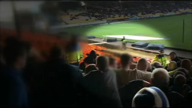 Football fans scuffle with a steward