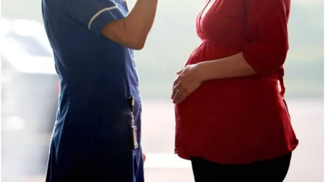 Pregnant woman with nurse