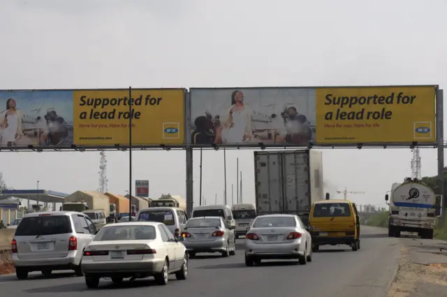 Motorists drive past a MTN billboard across Lagos-Ibadan expressway on November 15, 2015.