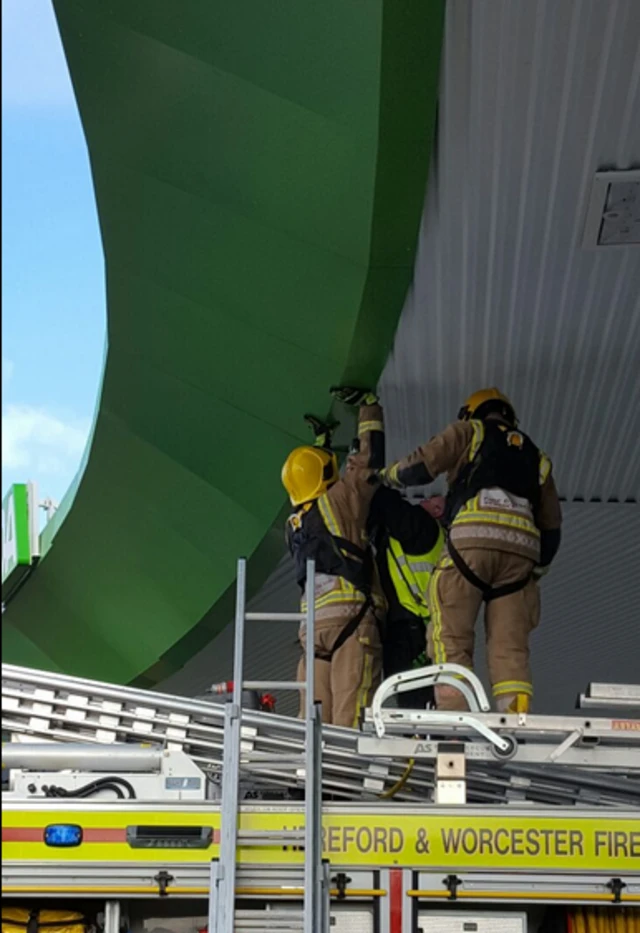 Fire officers gluing down roof