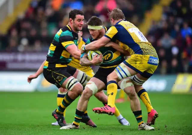 
          eimana Harrison of Northampton Saints is tackled by Dewald Potgieter of Worcester Warriors
        