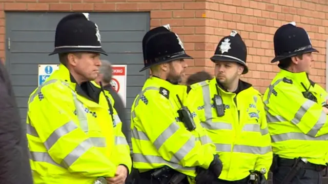 Four police officers in high viz clothing at Carrow Road