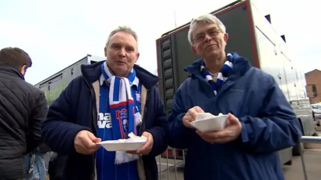 Ipswich fans eating takeaway food