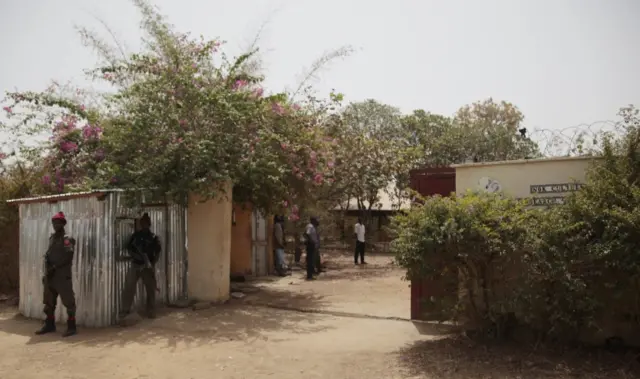 Officers on guard at a residence in Janjala Village, Nigeria