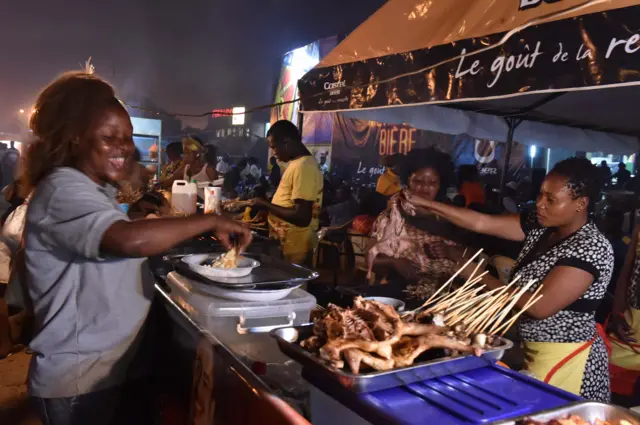 
          Women sell food during the Panafrican Film and Television Festival
        