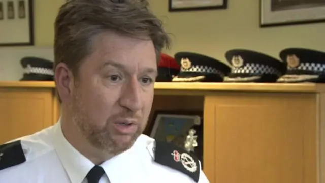 Simon Bailey, in uniform, in police office