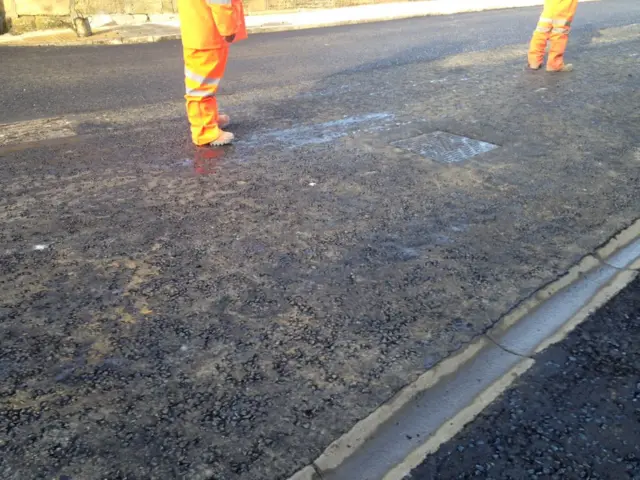 Men staring at tarmac