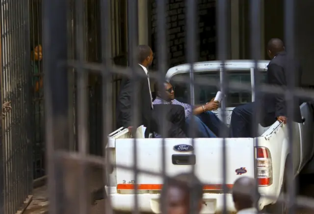 Zimbabwe Pastor Evan Mawarire, who led protests last year against President Robert Mugabe"s authoritarian government, arrives in handcuffs in the back of a pickup truck at the Harare Magistrates Court on February 3, 2017 in Harare.