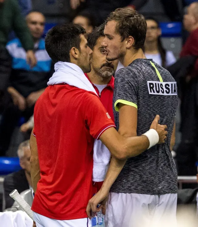 Daniil Medvedev (R) of Russia reacts after retireing from the Davis Cup World Group first round match against Novak Djokovic of Serbia