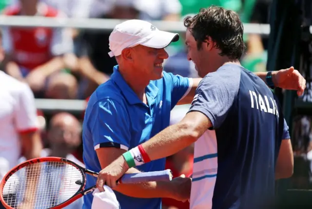 Italy"s team captain Corrado Barazzutti embraces player Paolo Lorenzi