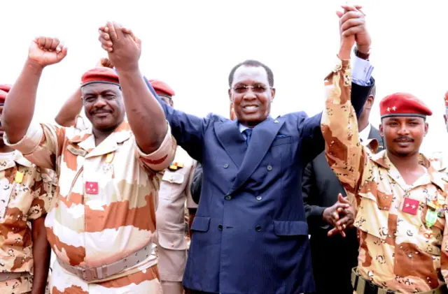 Chad's President Idriss Deby Itno (C) holds hands with General of the Chadian contingent in Mali Oumar Bikimo (L) and second-in-command major and his son Mahamat Idriss Deby Itno (R) during a welcome ceremony, on May 13, 2013, in N'Djamena.