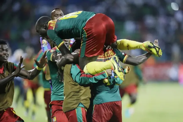 Christian Mougang Bassogog, obscured below right, and team mates celebrates after he scored a goal against Ghana during the African Cup of Nations semifinal soccer match between Cameroon and Ghana at the Stade de Renovation, in Franceville, Gabon, Thursday Feb. 2, 2017