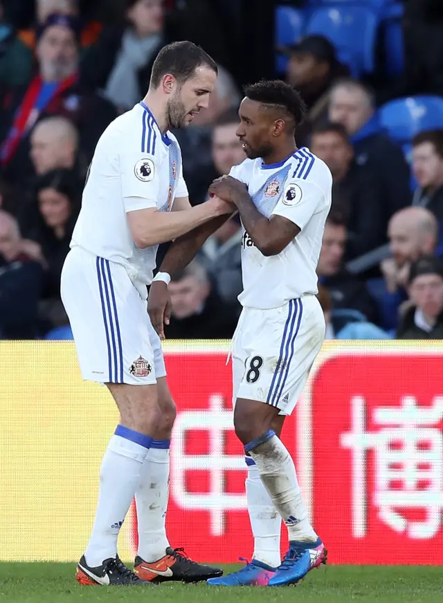 John O"Shea of Sunderland (L) gives Jermain Defoe of Sunderland (R) the arm band as he is subbed off