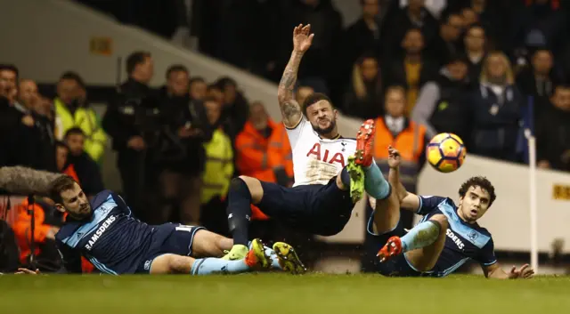 Kyle Walker is tackled by two players