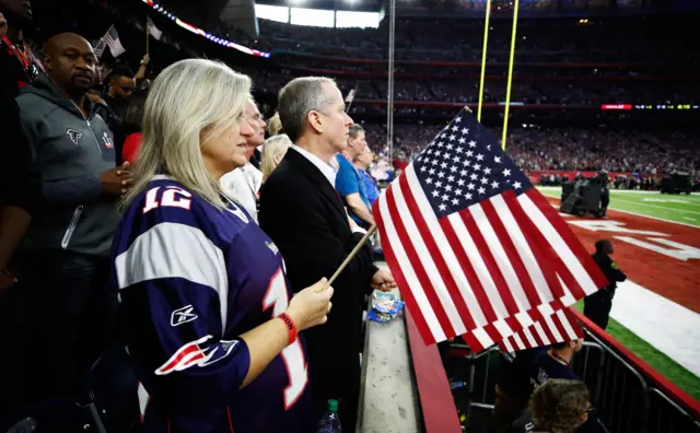 Fans stand for the national anthem