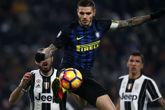 Inter Milan"s forward Mauro Emanuel Icardi from Argentina (top) fights for the ball with Juventus" defender Giorgio Chellini