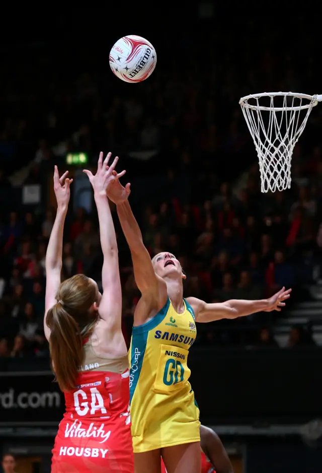 Helen Housby of England shoots past April Brandley of Australia