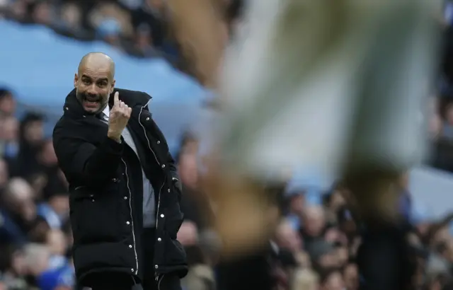 Pep Guardiola gestures on the touchline