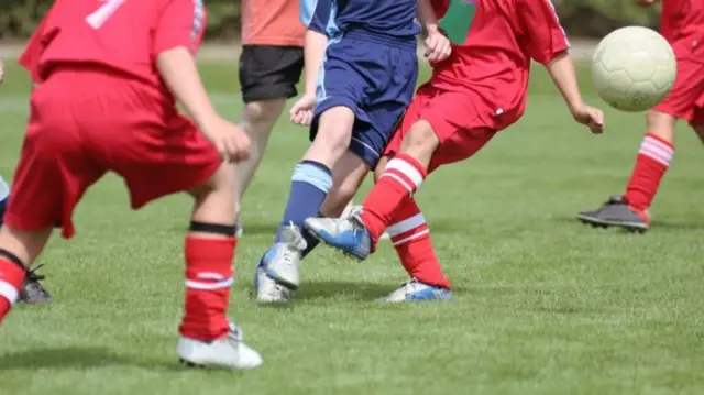 Youths playing football