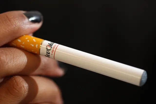 A woman smoking an e-cigarette