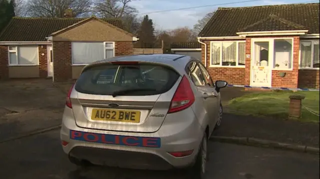 Police vehicle parked outside bungalow