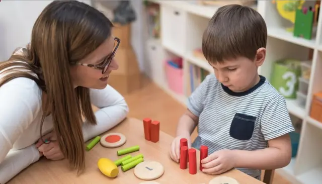 A nursery nurse with todddler