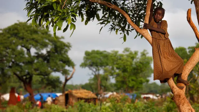 A girl in a tree in South Sudan