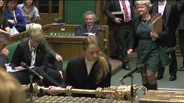 A clerk removes the mace