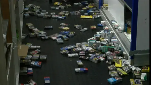 Cigarette packets strewn across the floor after break in