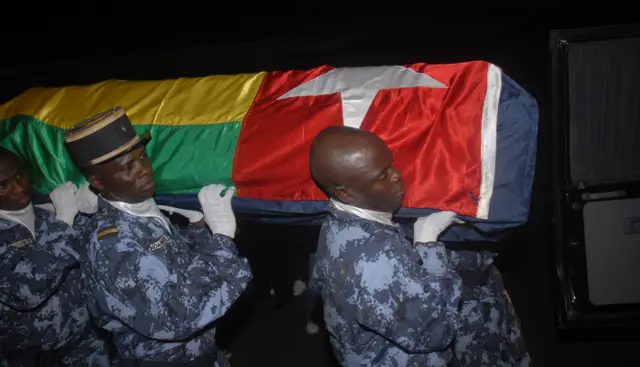 Togolese gendarmes carry the coffin wrapped in the national flag of one of the victims of the Flec attack that killed two of members of the Togolese national football team on January 8, 2010