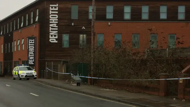 Shopping trolley cordonned off on pavement by police tape