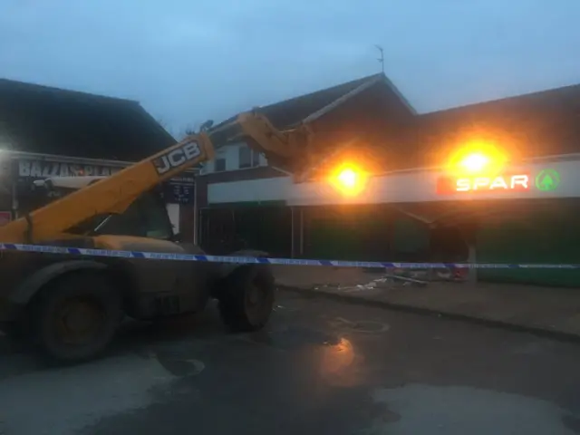 Police corden around fork lift and SPAR