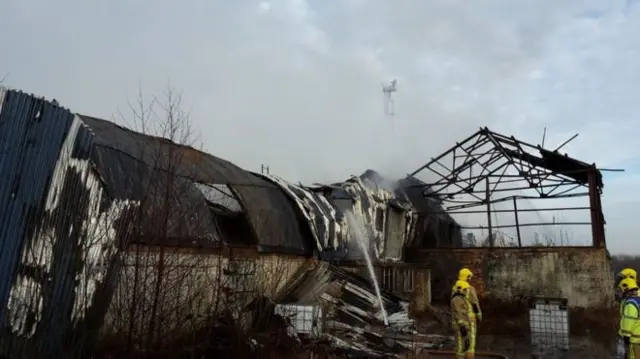 The building at the recycling plant with firefighters there