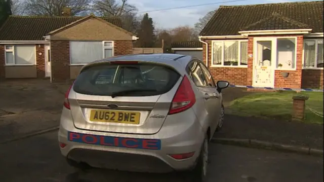 Police vehicle outside the scene of murder