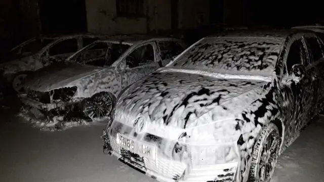 Cars covered in white foam