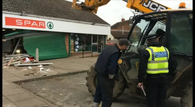 Police inspecting JCB digger